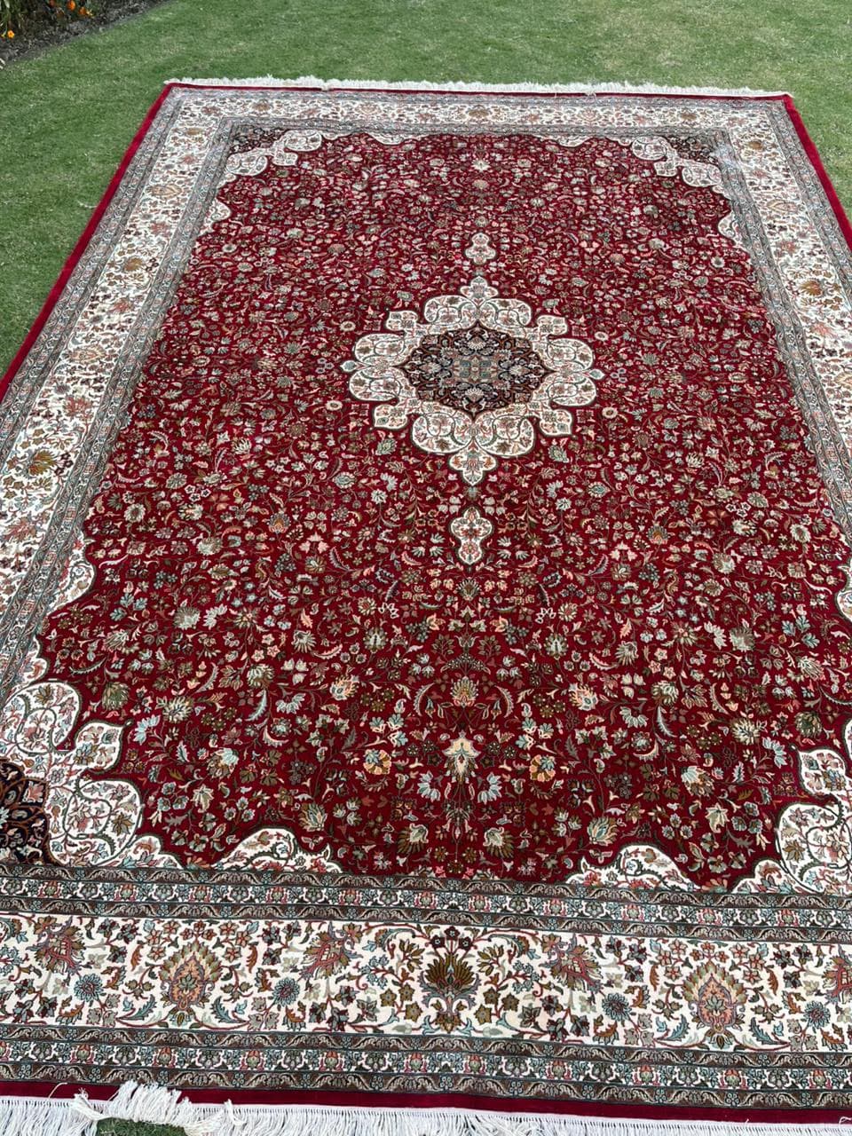 Red medallion silk rug with ivory border