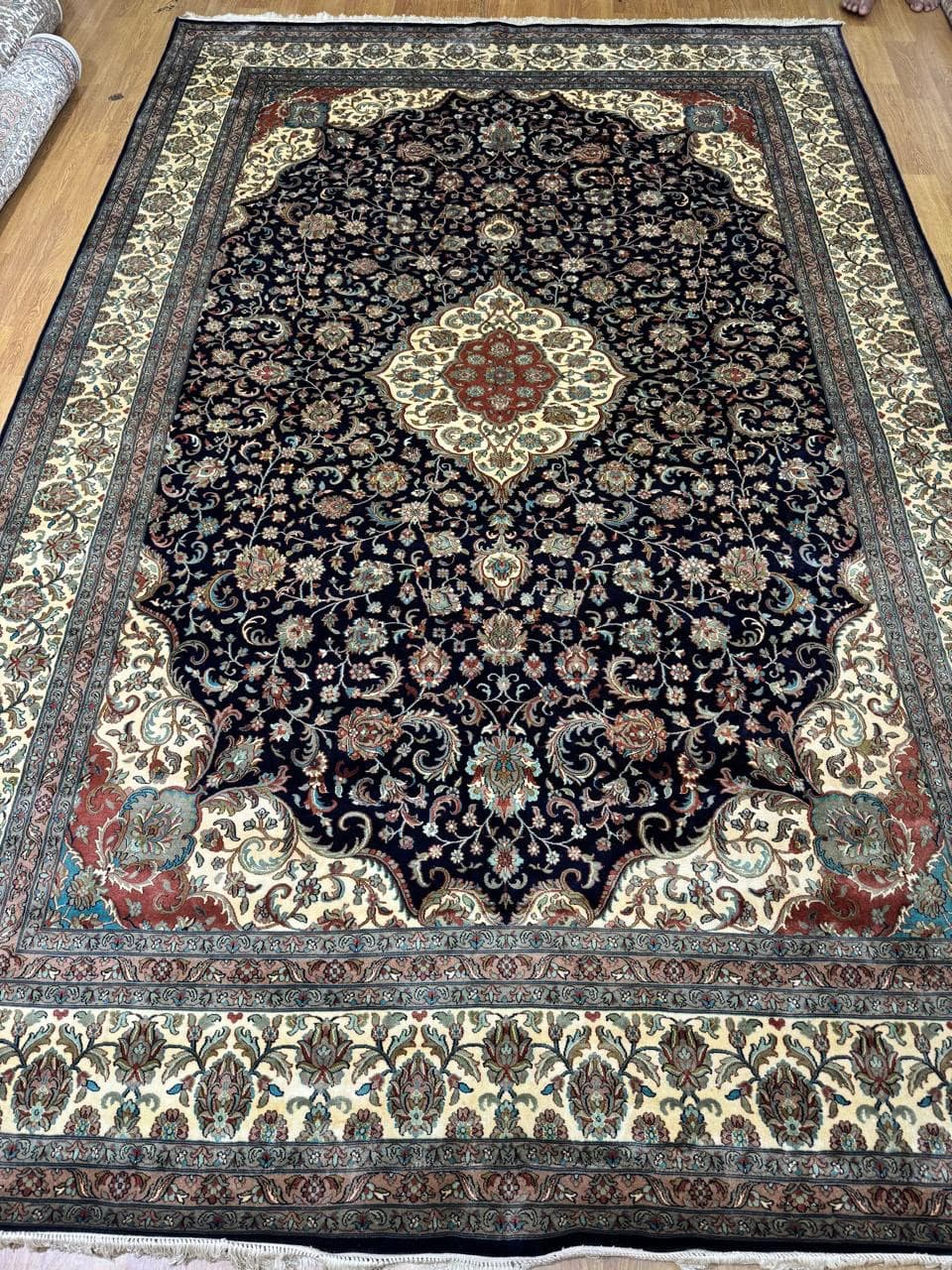 Navy medallion silk rug with cream border